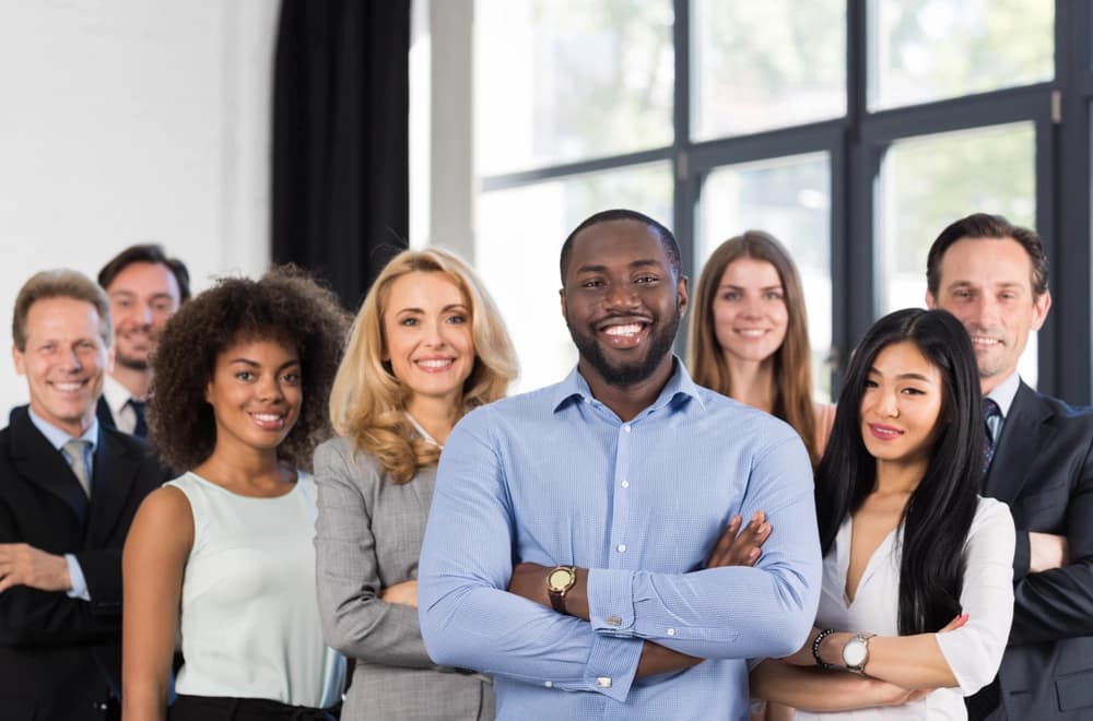 Racially and sexually diverse team with smiling faces